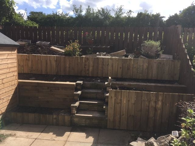 A couple of retaining walls, fencing, a shed and some flagstones later